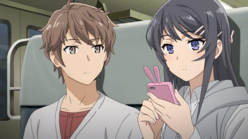 Two main characters from the anime, Sakuta Azusagawa and Mai Sakurajima, traveling together in a train.